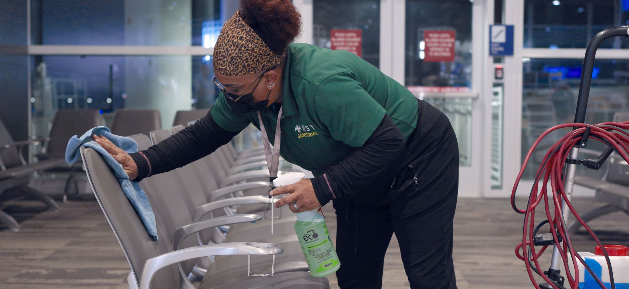 Custodian wiping down airport seats using E23 Eco Neutral Disinfectant